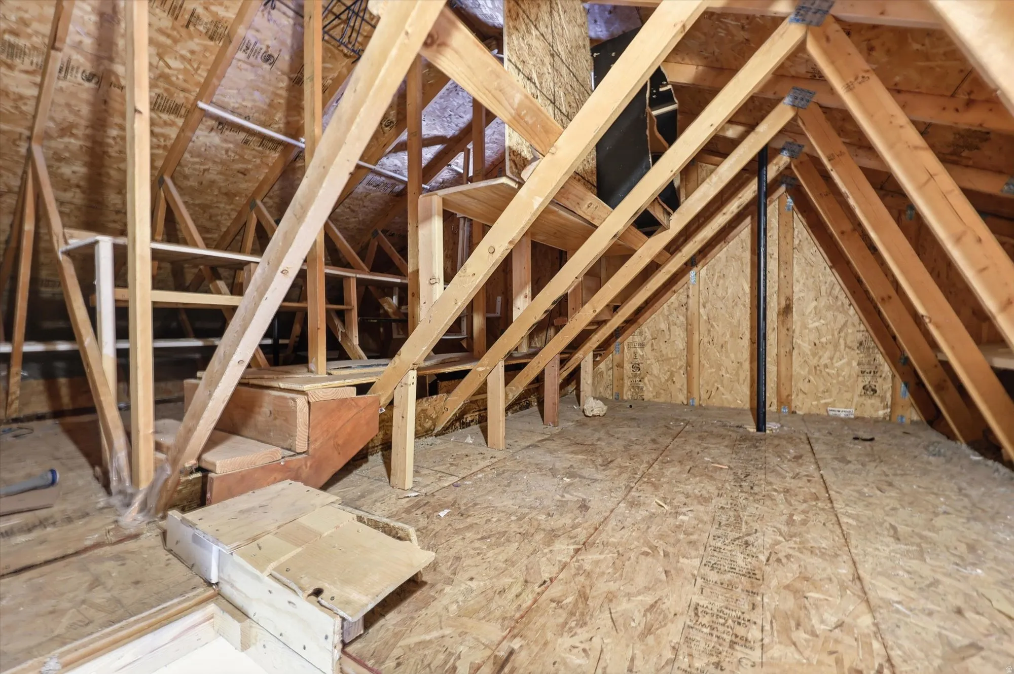 Attic with built in shelving for storage.