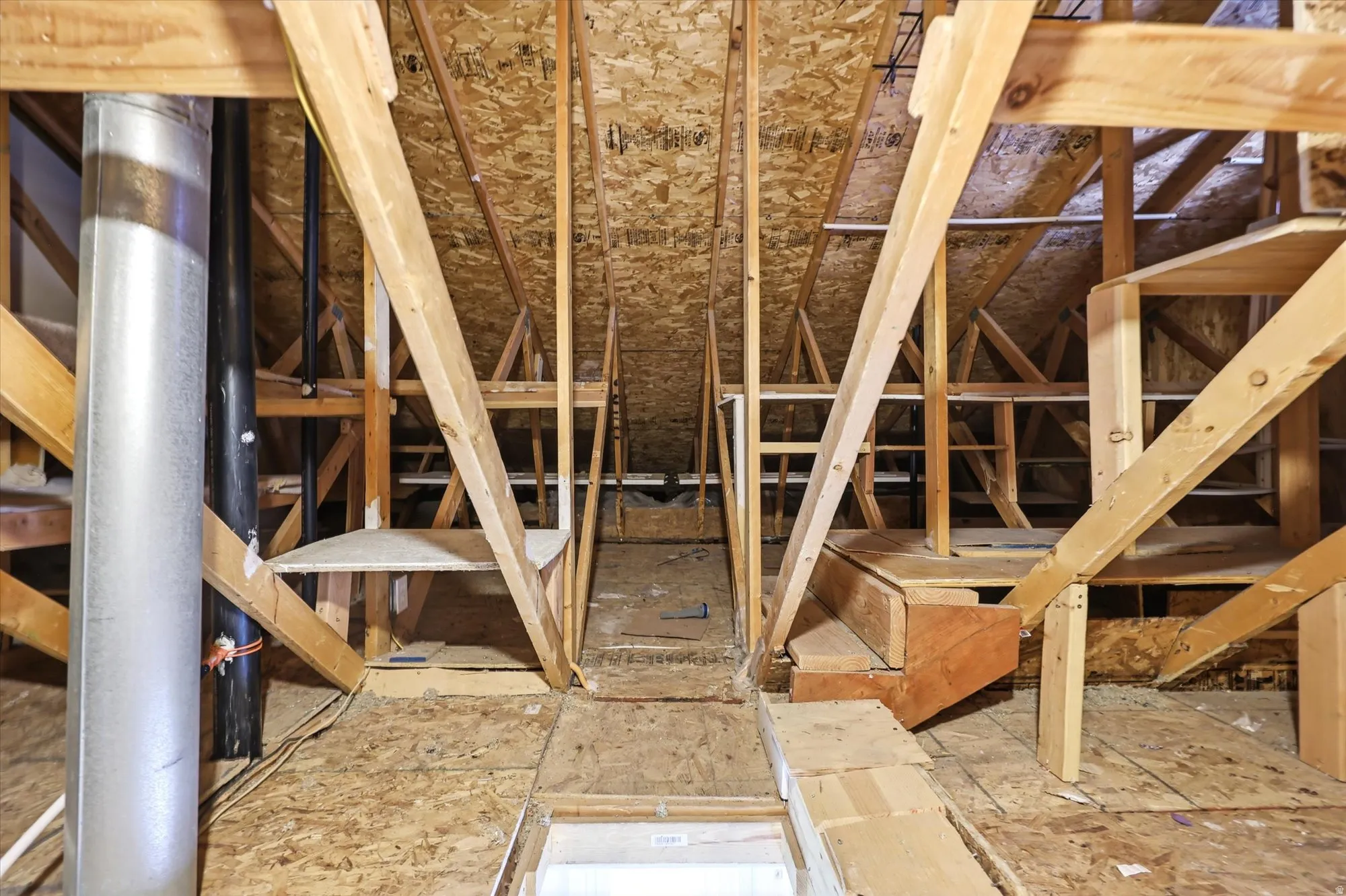 Attic with built in shelving for storage.