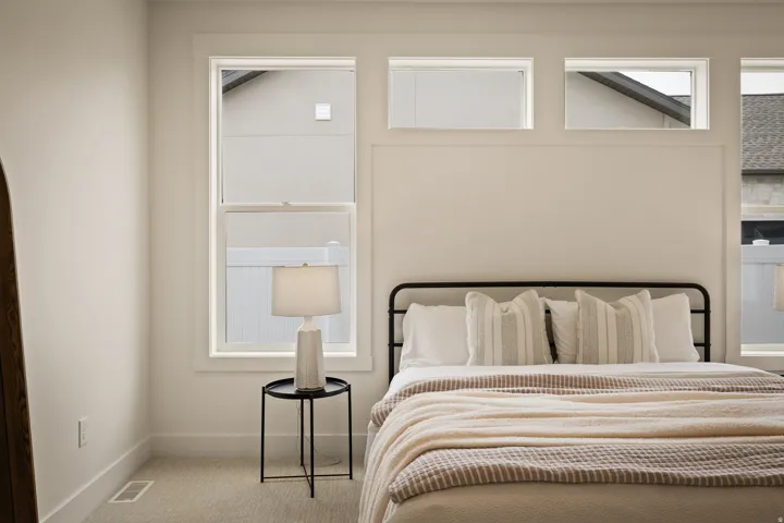Tall windows with transom accents, white trim, and light-colored walls