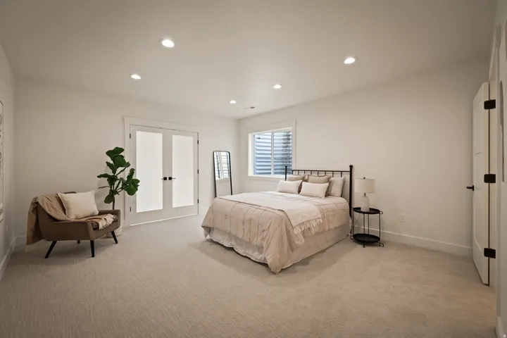 ADU oversized ADU bedroom with plush carpeting, recessed lighting, white trim, and a window with blinds