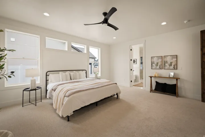 Recessed lighting, ceiling fan, carpeting, white trim, and a door frame to an additional space