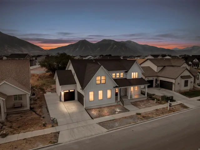 Modern farmhouse style exterior featuring white siding and dark trim