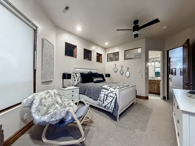 Recessed lighting, ceiling fan, carpeted flooring, and a large window with roller shade