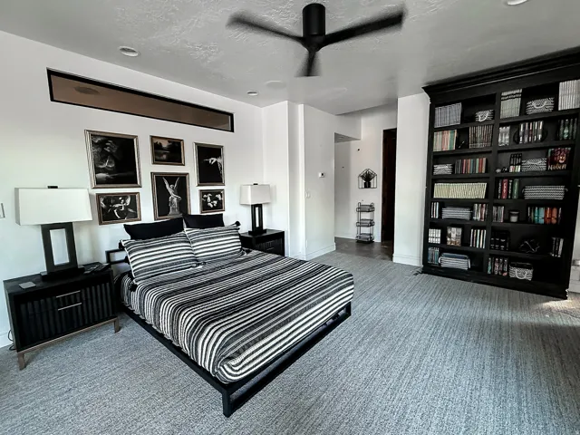 Built-in shelving, high ceilings, recessed lighting, and a linear transom window