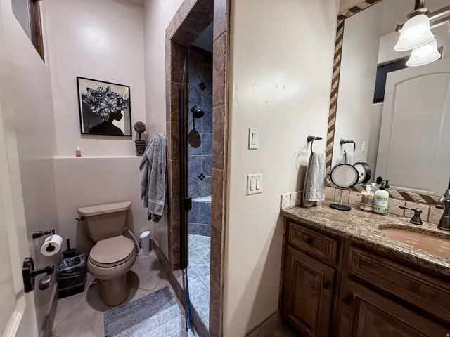 Warm-toned vanity with stone countertop and integrated sink
