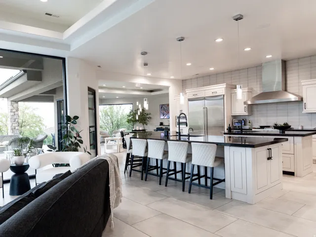 Gourmet kitchen with an expansive island, stainless steel appliances, and a tile backsplash