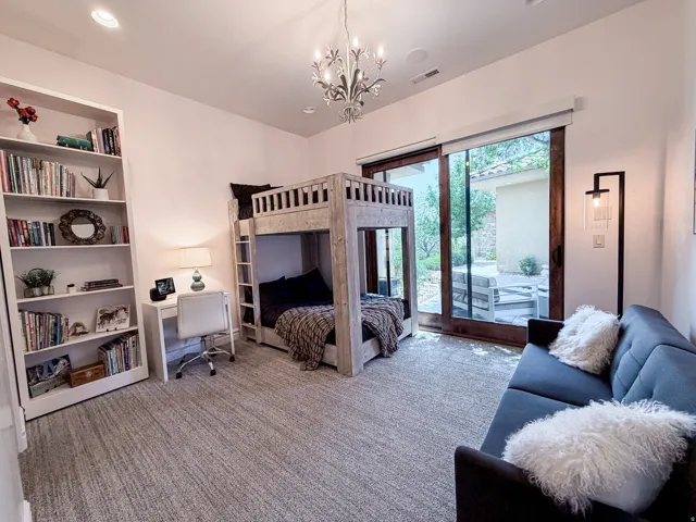 Built-in shelving, recessed lighting, and a chandelier fixture