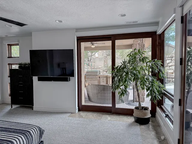 Recessed lighting and a ceiling fan enhance the space