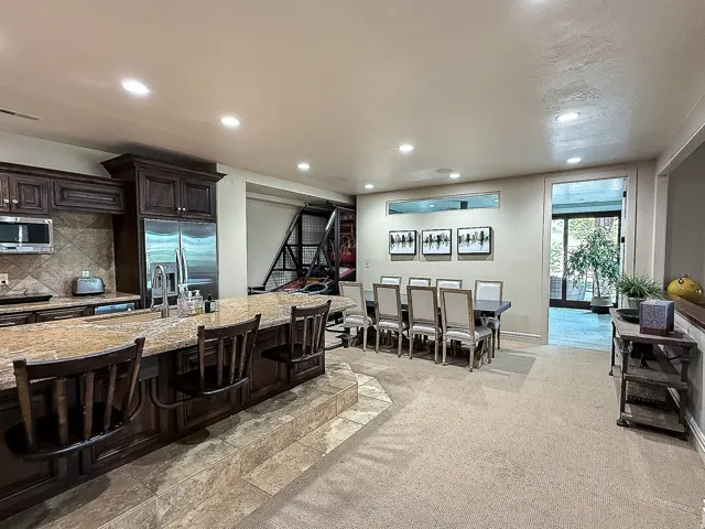 Spacious kitchen featuring rich wood cabinetry, granite countertops, and stainless steel appliances
