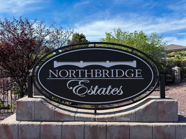 Northbridge Estates community sign featuring a black oval design with white lettering on a stacked stone base