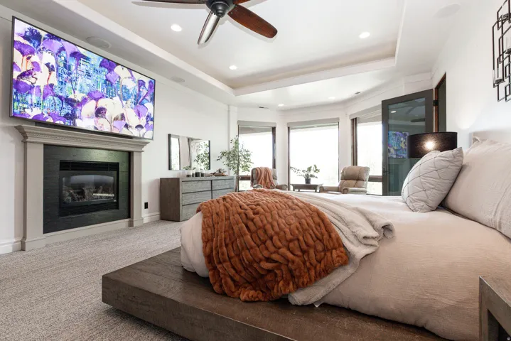 Recessed lighting, ceiling fan, fireplace with mantel, and bay windows