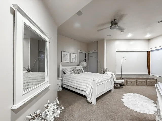 Vaulted ceilings with recessed lighting, ceiling fan, and built-in window seating with storage