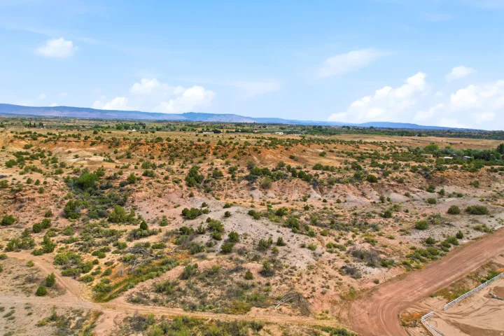 Expansive open terrain featuring natural desert vegetation and distant mountainous landscapes