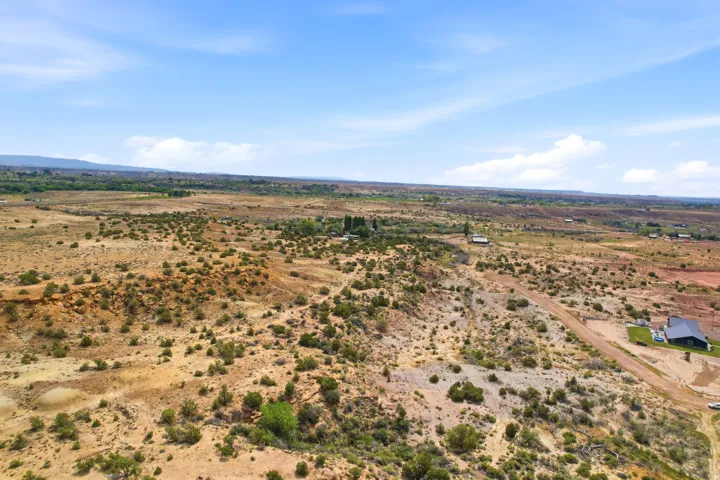 Expansive arid landscape with scattered low-lying vegetation