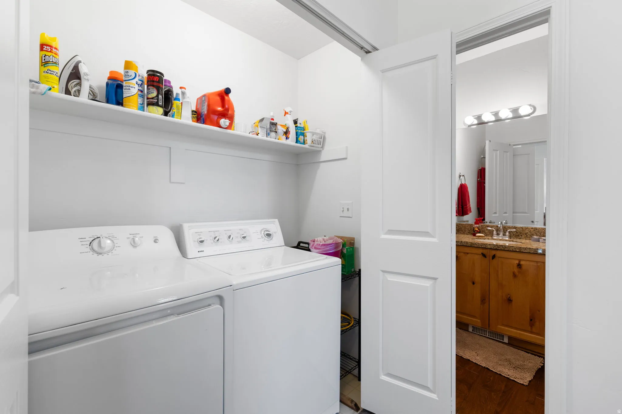 Dedicated laundry area featuring a white shelf for storage
