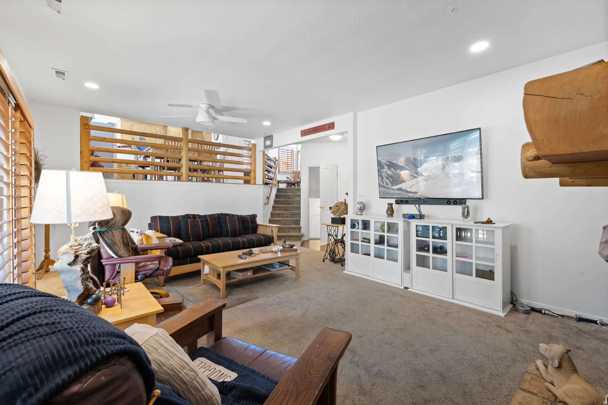 Spacious living area featuring carpet flooring and white walls