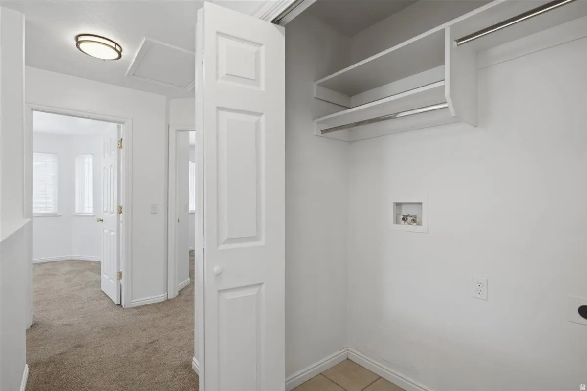 Laundry area with built-in shelving and hanging rods