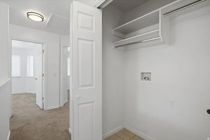 Laundry area with built-in shelving and hanging rods