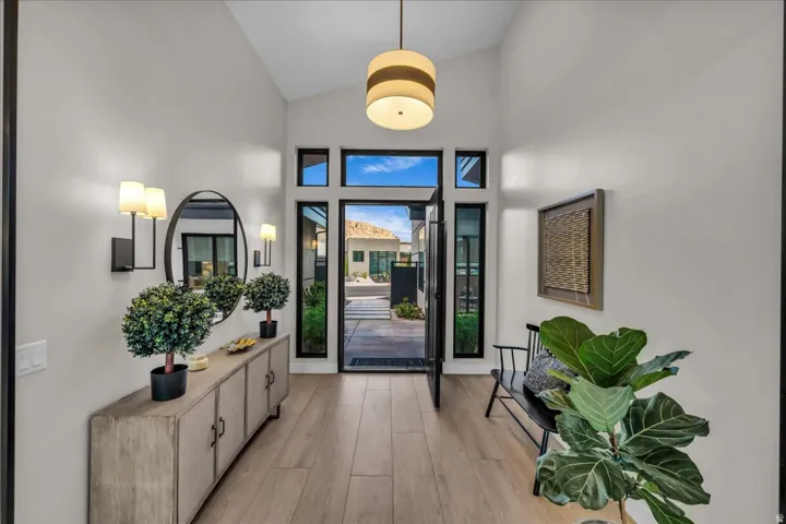 Vaulted ceiling entry with wood-finish flooring