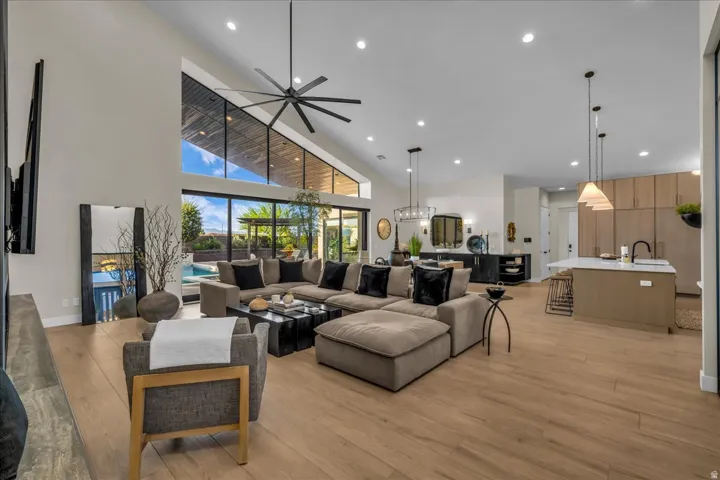 Soaring vaulted ceilings, expansive window walls, and wood-finish flooring define this open-concept living space