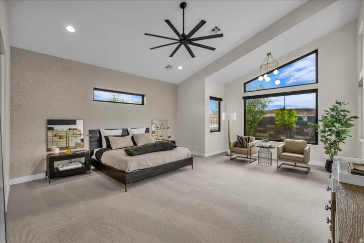 Vaulted ceilings, large picture windows, recessed lighting, and a modern ceiling fan