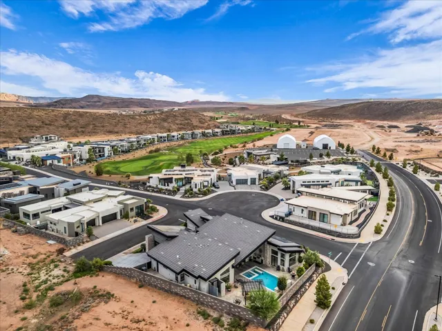 Modern desert community featuring contemporary architecture, integrated landscaping, and a golf course