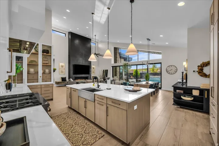Gourmet kitchen with a large central island, farmhouse sink, and integrated cooktop