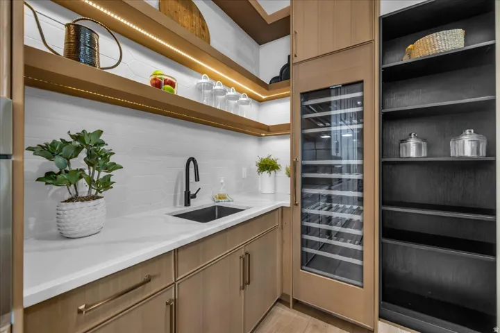 White countertop with an undermount sink and matte black faucet