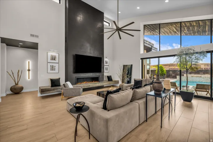 Soaring ceilings with a contemporary ceiling fan and large format windows
