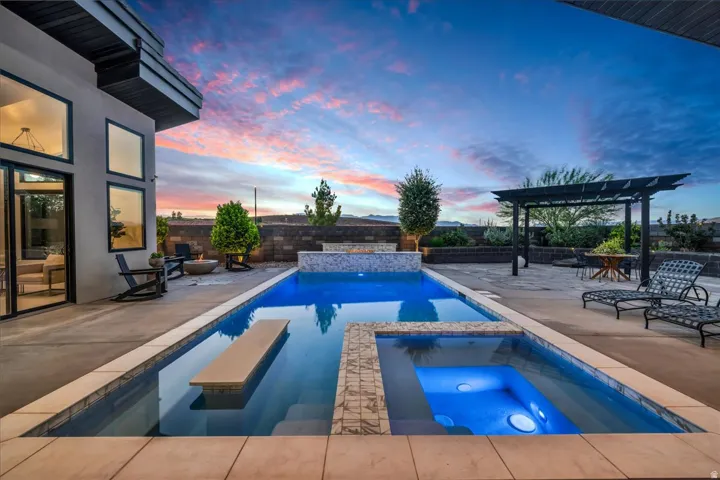 Contemporary exterior with large windows, an integrated swimming pool, and a separate elevated spa