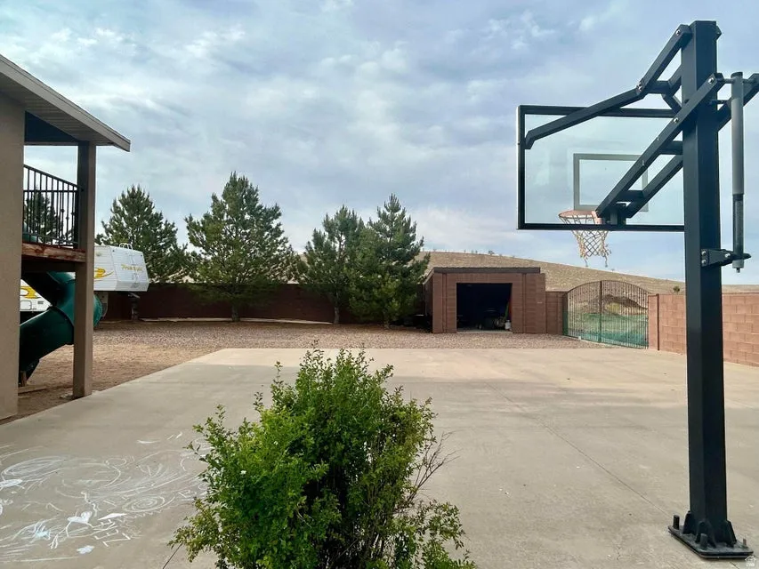 Paved concrete court with an adjustable basketball hoop