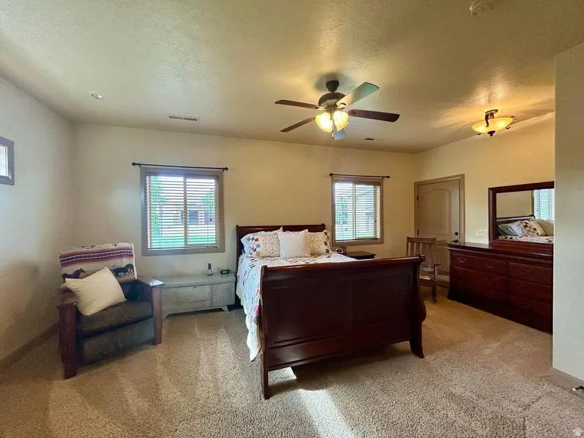 Recessed lighting, ceiling fan light fixture, additional ceiling light fixture, two windows with blinds, arched interior door