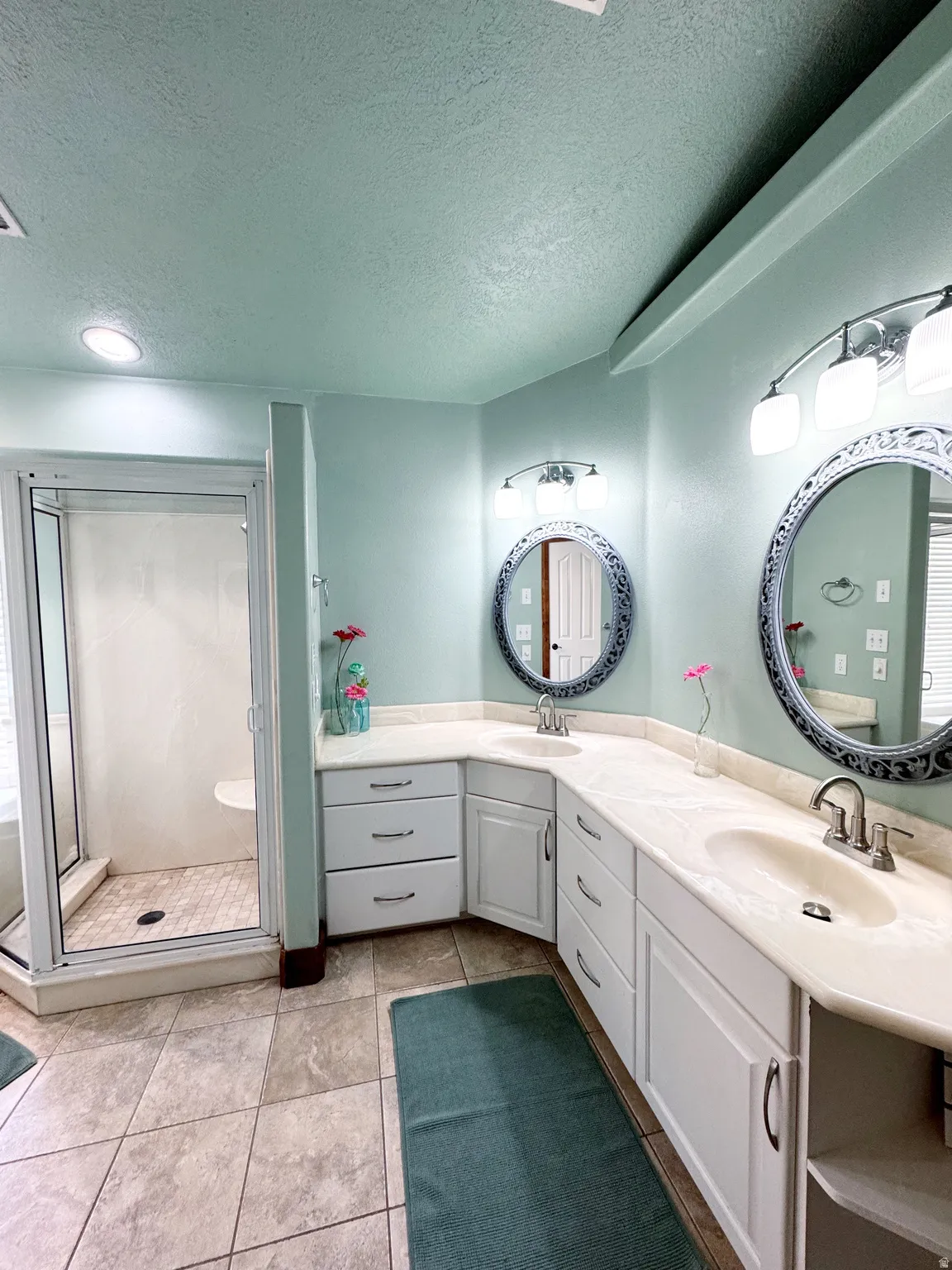 Dual vanity with undermount sinks, white cabinetry, and light-toned countertops