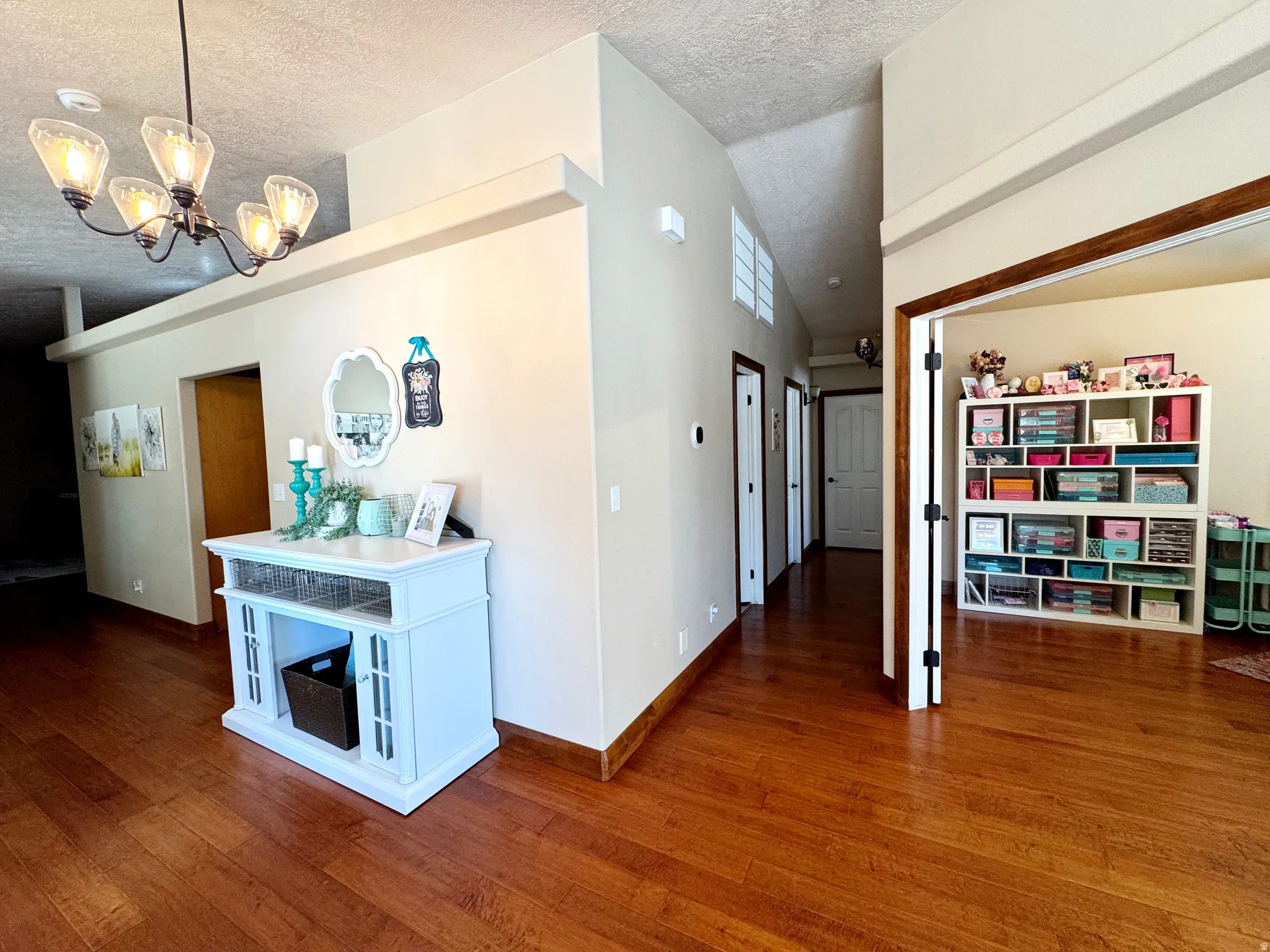Wood-finish flooring throughout, with a decorative ceiling light fixture
