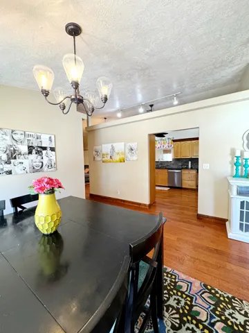 Hardwood flooring throughout, recessed lighting, and a modern chandelier