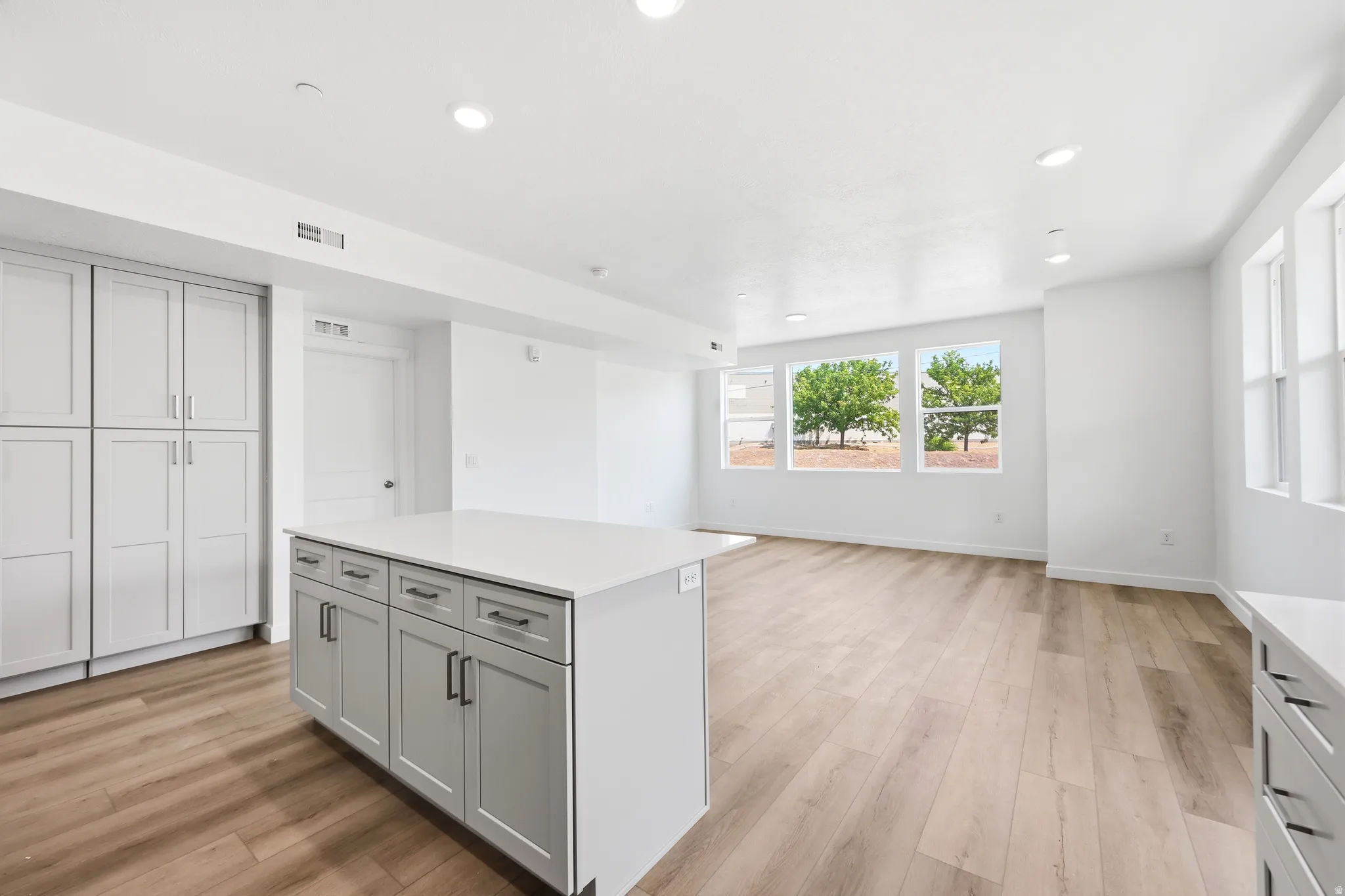 Light wood-finish flooring with recessed lighting