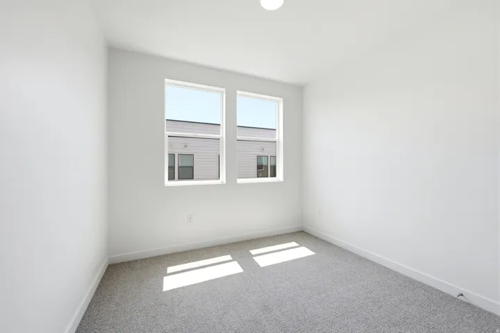 Neutral tone walls with soft carpet flooring