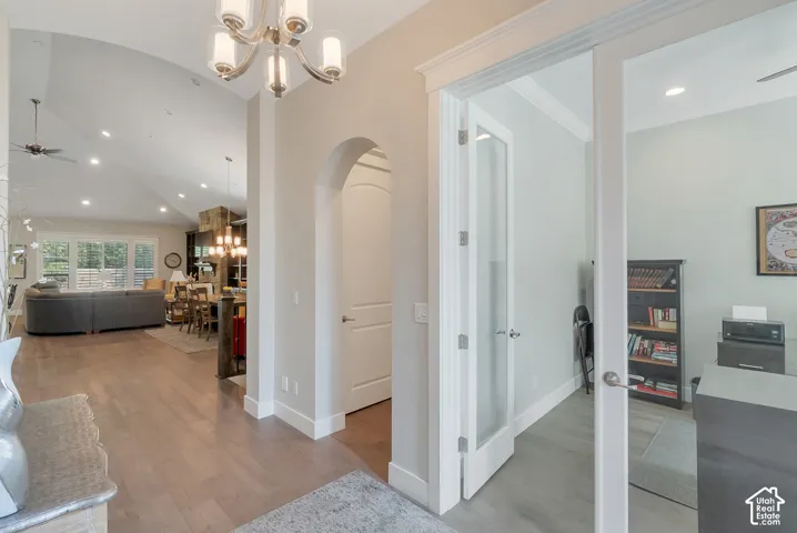 Hardwood-finish flooring throughout, vaulted ceiling, recessed lighting, arched doorway, and a spacous home office.