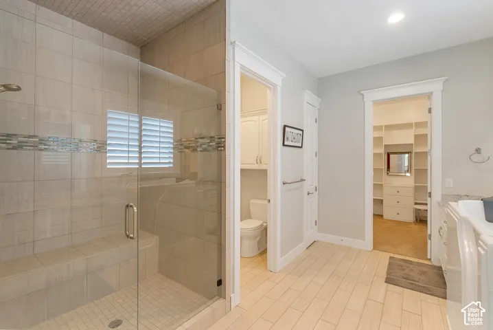 Glass-enclosed shower with a tiled bench and decorative accent band