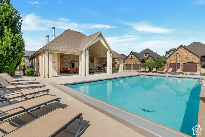 Expansive swimming pool with integrated tanning ledge, surrounded by a concrete deck