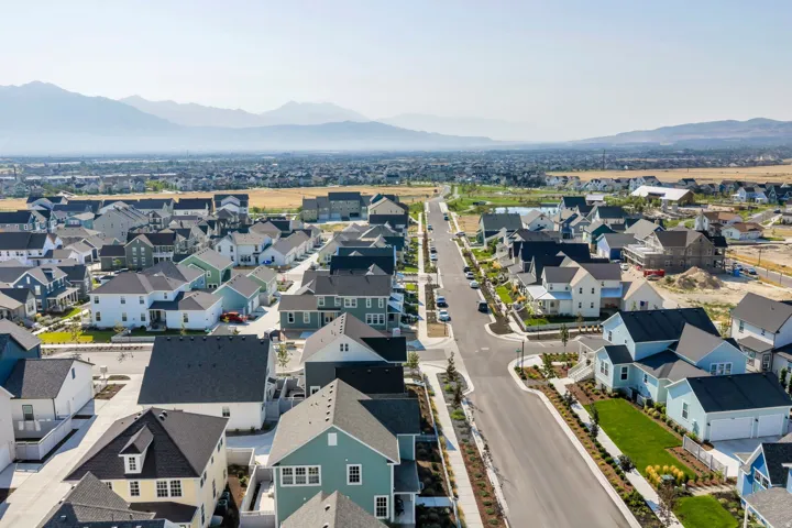 Newly constructed residential community featuring a variety of architectural styles, expansive landscaped streets, and mountain scenery