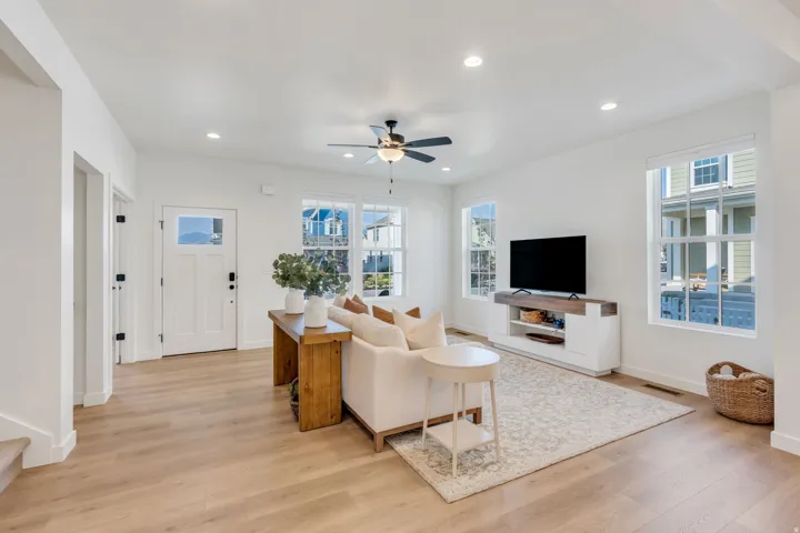 Open concept living area with wood-finish flooring, recessed lighting, and a ceiling fan