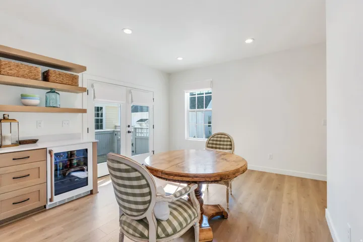 Built-in cabinetry with wood-finish floating shelves, white countertop, and integrated beverage refrigerator