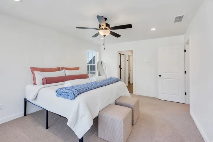 Recessed ceiling lighting, a ceiling fan with light fixture, carpeted flooring, and a two-panel interior door with matte black hardware