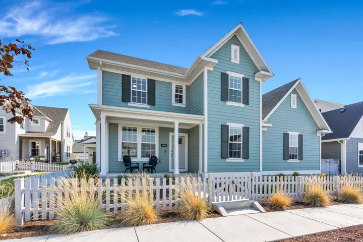 Two-story siding exterior with multiple gables and a covered front porch