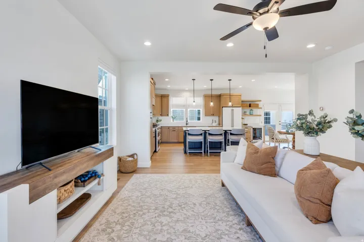 Open concept living area with recessed lighting and wood-finish flooring
