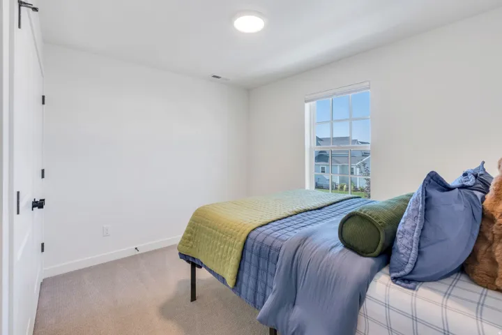 Carpeted flooring, white walls, recessed lighting, and a multi-pane window