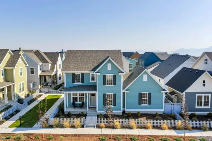 Two-story residence with a covered front porch and a picket fence