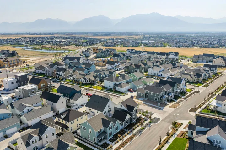 New construction community with varied architectural styles, asphalt streets, and paved sidewalks