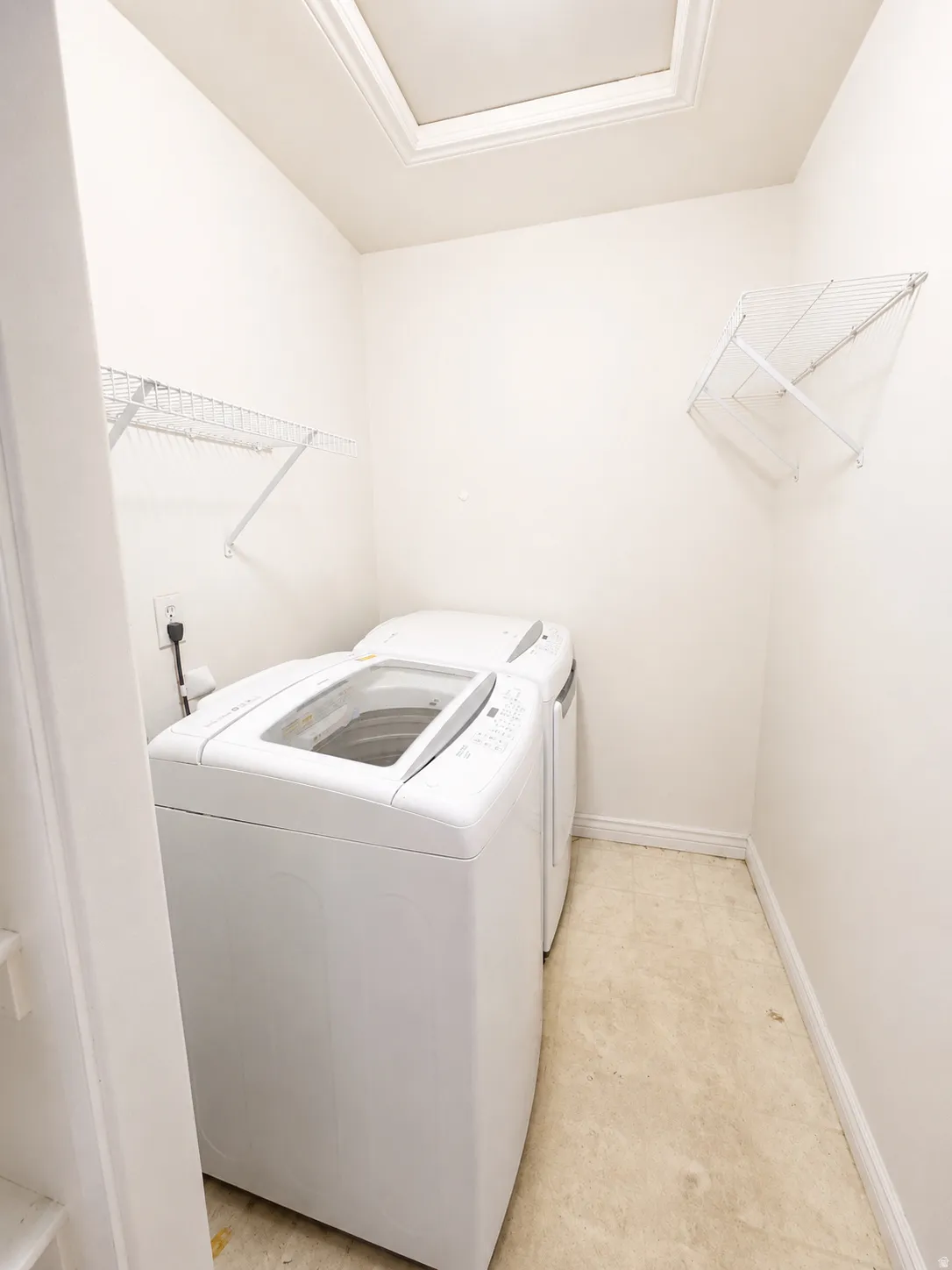 Skylight feature, white wire shelving, and neutral tone flooring